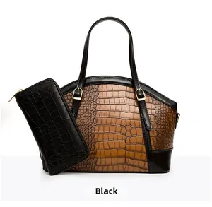 Detail of crocodile embossed leather tote bag set with matching zip wallet and gold hardware