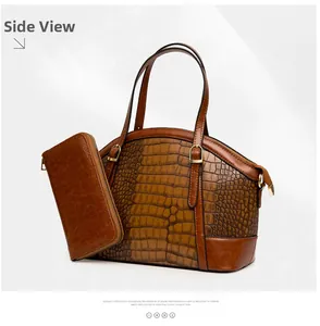 Detail view of brown crocodile-textured dome handbag and matching zip-around wallet set