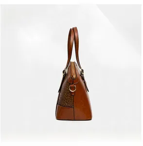 Detail view of brown crocodile embossed pattern on retro faux leather handbag
