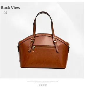 Back view of brown retro leather handbag featuring a zipper pocket and gold hardware