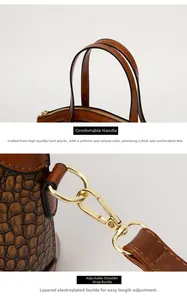Detail of brown crocodile pattern handbag with golden hardware and durable handle