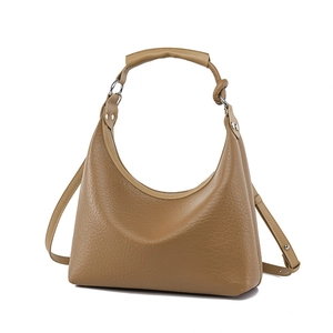 Chic camel faux leather bucket bag with pebble grain texture and adjustable shoulder strap