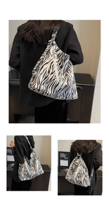 Detail of zebra pattern canvas bag showing multi-way shoulder and backpack straps