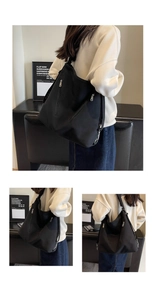 Detail of black large canvas tote bag featuring double metal front zipper pockets