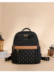 Detail of black quilted oxford backpack with gold studs and orange textured decorative strap