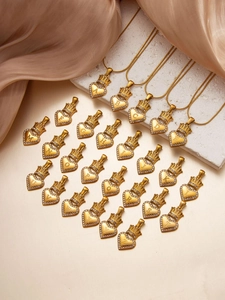Macro shot of 26 alphabet heart pendants with gold crown detail and shimmering zircon stones