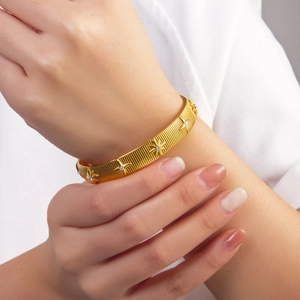 Adjustable 18k gold plated stainless steel starburst bangle with brushed texture finish