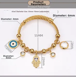 Detail view of adjustable 18K gold hand of fatima bangle with evil eye and crystal charms