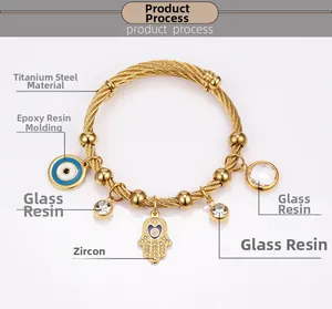 Detail of 18K gold stainless steel bracelet with Hamsa Hand and Evil Eye charms