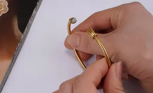 Close-up of 18K gold stainless steel bracelet with snake chain and magnetic closure