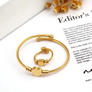 18K gold plated heart charm twisted wire bangle and ring jewelry set on white background