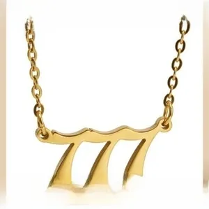 Detailed close-up of a gold-plated stainless steel 777 lucky number pendant with O-chain