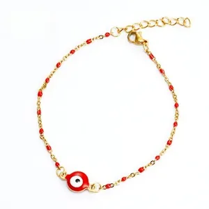 Close-up of golden Evil Eye chain bracelet with red beads and adjustable lobster clasp