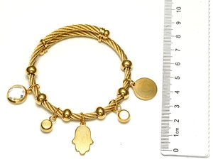 Detail of gold braided steel wire bracelet with Fatima hand charm and size reference ruler