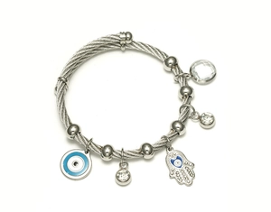 Detail of silver twisted wire cable bracelet with evil eye and Hamsa hand charms