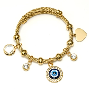 Gold wire bangle with blue evil eye pendant, golden heart, and crystal charms