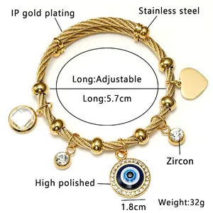 Detail of adjustable gold stainless steel rope bracelet with evil eye and zircon charms