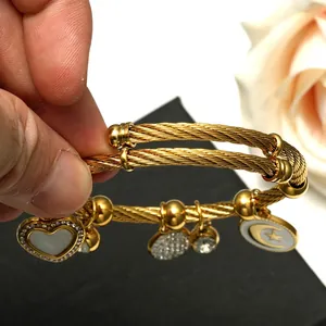 Bracelet torsadé doré avec pendentifs cœur en nacre et célestes sertis de cristaux