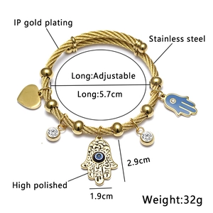 Detail showing 18K gold plated stainless steel wire bracelet with evil eye pendants
