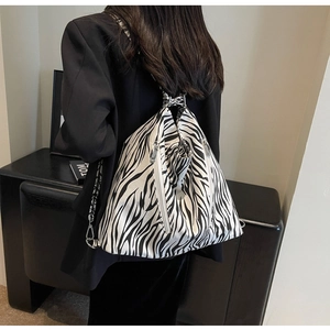 Zebra print canvas backpack with large capacity and side zipper shown on model