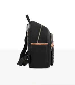 Side view detail of black Oxford backpack featuring gold zippers and brown animal print trim