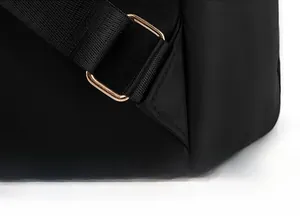 Reinforced triangular stitching on black oxford nylon backpack shoulder strap with metal buckle
