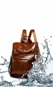 Close-up of vintage brown PU leather backpack showing water-resistant surface and texture