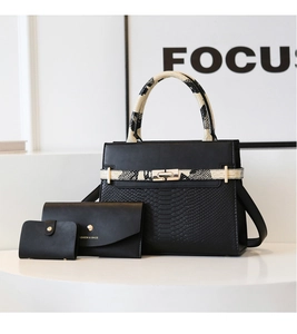 Three-piece black handbag set featuring snake print handles and gold-tone hardware detail