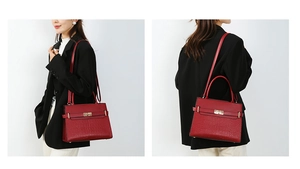 Macro view of a red handbag showing crocodile embossed texture and golden metal lock details