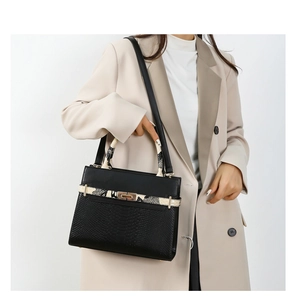 Classic black faux leather handbag with snake pattern handle and gold clasp detail
