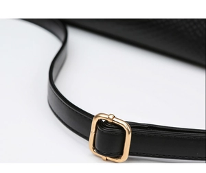 Detail of adjustable gold buckle on high-quality black leather shoulder strap