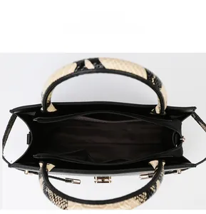 Top view of large tote bag interior showing zipper pocket, main compartment and gold hardware