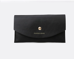 Detail of black leather handbag with gold round buckle and Fashion & Bags gold lettering