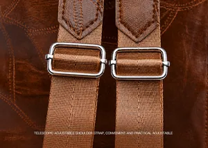 Detail of adjustable shoulder strap with silver buckle on vintage brown backpack