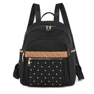 Women's black Oxford fabric backpack with diamond quilted rivets and large capacity