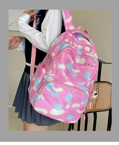 Side view of pink galaxy pattern backpack with astronaut charm on a female model