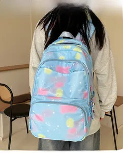 Detail of light blue nylon backpack with starry gradient pattern on model