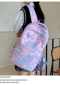 Detail view of pink nylon backpack with galaxy patterns and breathable mesh straps