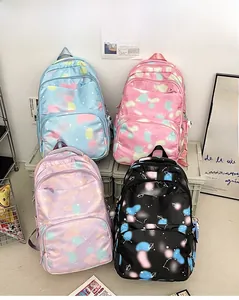 Detail view of four colorful nylon backpacks with galaxy prints and multiple zipper pockets