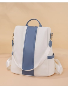 Detail of color-block backpack side pocket and adjustable woven strap in studio light