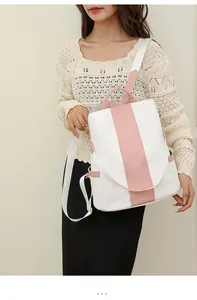 Asian model wearing white and pink bicolor soft leather backpack with gold hardware details