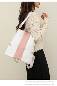 Detail view of large capacity white and pink leather backpack for women shown on model