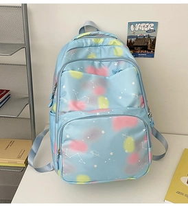 Detail of light blue starry nebula printed backpack with multiple functional pockets