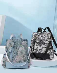 Detail view of two nylon floral backpacks with anti-theft design and side pockets