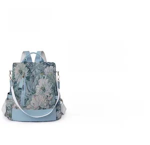 Close-up of floral jacquard nylon backpack featuring light blue leather base and side pocket