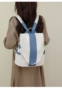 Rear view of a stylish color-block anti-theft backpack for women in white and blue