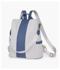 Side view of beige and blue color-block women's backpack with adjustable fabric straps