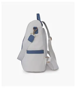 Side view of multi-functional backpack with blue and white color-block and metal hardware