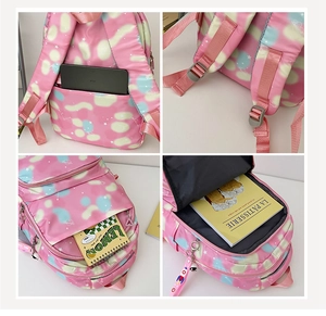 Detail view of pink nylon backpack showing anti-theft back pocket and multi-layer storage compartments