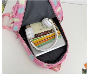 Top view of spacious pink tie-dye backpack showing interior storage for laptop and books